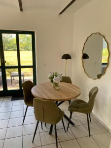 a dining room with a table and chairs and a mirror at Smeers Hof in Böhme