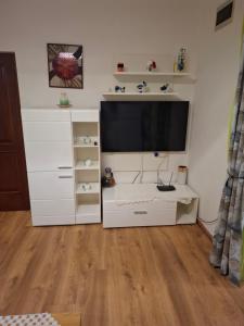 a white entertainment center with a flat screen tv at Guesthouse Mirjana in Premantura
