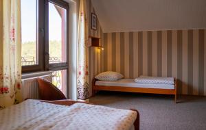 a room with two beds and a window at Pokoje Iza in Chałupy