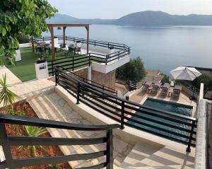 a house with a pool and a view of the water at Secret Villa in Vlorë