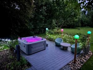 a hot tub sitting on top of a wooden deck at Riverbank Cottage in Lancaster