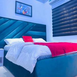 a blue and red bed in a bedroom at MyTime Hotel in Tamale