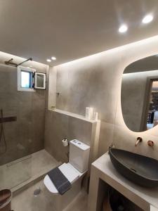 a bathroom with a black sink and a shower at House Karga in Ormos Panagias