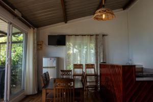 a kitchen and dining room with a table and chairs at Residence Foulsafat in Rodrigues Island