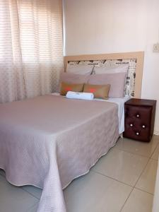 a bedroom with a large bed with white sheets and pillows at Uptown Inn GuestHouse in Parys +17 photos