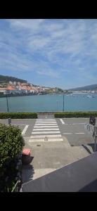 a parking lot next to a large body of water at Alborada in Corcubión