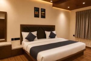 a bedroom with a large bed in a room at Luxora Suites in Jaipur +18 photos