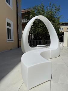 a white chair sitting in front of a mirror at Galerie Hotel in Bad Reichenhall