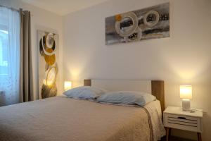 a bedroom with a bed with two pillows at Guesthouse Mirjana in Premantura