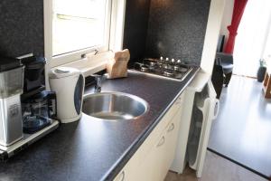 a kitchen with a sink and a counter top at Chalet nr 43 in Molkwerum