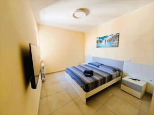 a bedroom with a bed with a bag on it at MS Sea Port Rooms in Ancona
