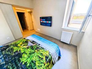 a bedroom with a bed and a tv on the wall at MS Sea Port Rooms in Ancona