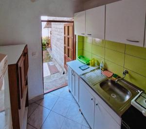 a kitchen with a sink and a counter top at Camping 999 Jablaničko jezero in Železnička Stanica Ostrožac +69 photos