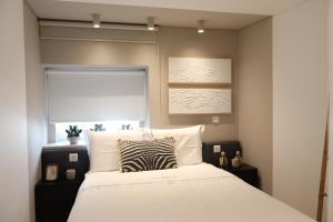 a bedroom with a bed with a zebra pillow on it at Tinico's Guest Rooms in Nazaré