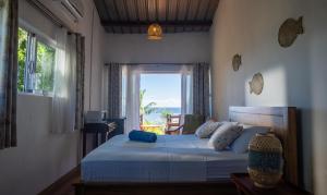 a bedroom with a bed with a view of the ocean at Residence Foulsafat in Rodrigues Island +148 photos