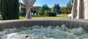 a water fountain in a park with a playground at Apartmani Ćosić in Kuršumlija