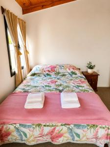a bedroom with a bed with two towels on it at Miniloft Centrico in El Calafate