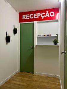 a red and green door in a room with a repsol sign at 7 Requinte HOSTel in Lisbon