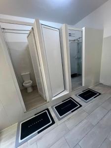 a bathroom with three mirrors and a toilet at 7 Requinte HOSTel in Lisbon +23 photos