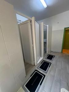 a bathroom with two doors and two mirrors on the floor at 7 Requinte HOSTel in Lisbon