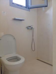 a bathroom with a toilet and a shower at Onar Myrties in Myrties +17 photos