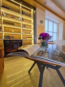 an open book sitting on a coffee table in a living room at In Grand Hotel & SPA in Bucharest