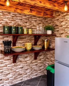 a counter with plates and bowls on a brick wall at Les Clés de Parys in Parys