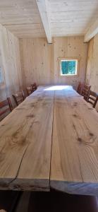 a large wooden table in a room with chairs at iDILe in Râșca