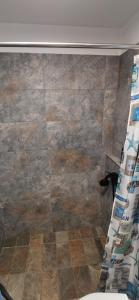 a bathroom with a shower curtain and a tile floor at iDILe in Râșca +18 photos