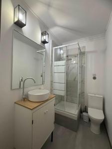 a bathroom with a sink and a shower and a toilet at Beach apartment's in Limassol +82 photos