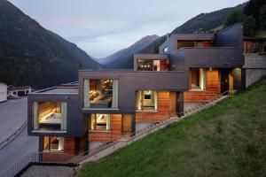 a house on a hill with mountains in the background at Aradira in Kappl
