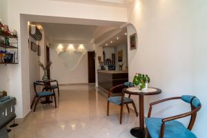 a hallway with chairs and a table in a room at Achillion in Paralia Katerinis