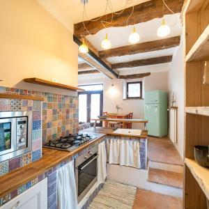 a kitchen with a stove and a counter top at Rifugio Vita Luminosa in Montecarotto