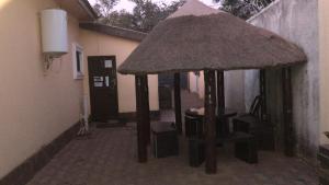a small pavilion with a table and chairs in a building at Queen Room self contained in Lusaka