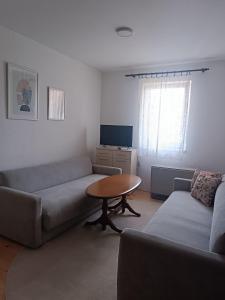 a living room with a couch and a table at Vikendica Miki 2 in Bratunac