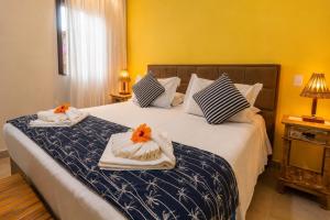 a bedroom with a bed with towels on it at Pousada Casa Cajá in Arraial d'Ajuda +79 photos