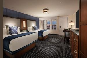 a hotel room with two beds and a desk at Hyannis Harbor Hotel in Hyannis +26 photos