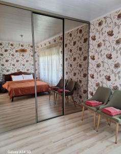 a bedroom with a bed and two chairs at Soliid Apartment in Pärnu