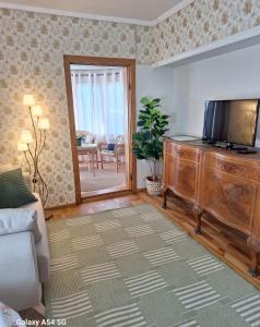 a living room with a flat screen tv on a dresser at Soliid Apartment in Pärnu