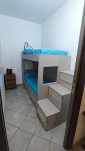 a bunk bed in a room with blue sheets at Basilicata Host To Host - BORGO SAN BASILIO 2 in Marina di Pisticci