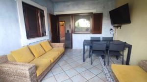a living room with a couch and a table at Basilicata Host To Host - BORGO SAN BASILIO 2 in Marina di Pisticci