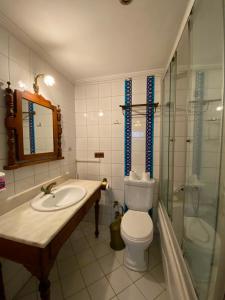 a bathroom with a sink and a toilet and a shower at Ramonun Yeri in Istanbul