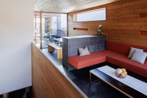 a living room with a red couch and a table at Aradira in Kappl