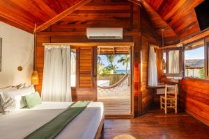 a bedroom with a bed and a desk and a balcony at Hurricane Jeri in Jericoacoara +195 photos