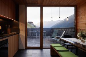 a kitchen with a balcony with a table and chairs at Aradira in Kappl