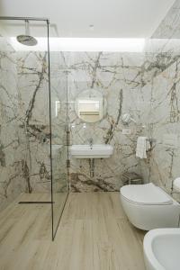 a bathroom with a sink and a toilet at Laid Hotel in Vlorë +84 photos
