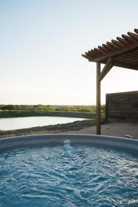 a swimming pool with a view of a body of water at Stargazer Dome Retreat in San Marcos