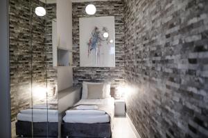 een kamer met een bed en een bakstenen muur bij MaVa Apartments in Wenen