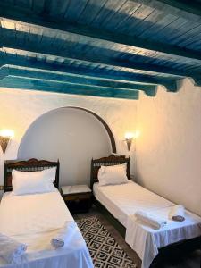 two beds sitting next to each other in a room at Houch Taguermess in Taguermess +6 photos