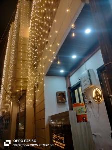 a staircase with christmas lights hanging from the ceiling at Hotel Shree shivay omkareshwar in Godarpura